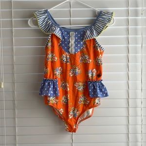 The brand is Matilda Jane. Size 12. Orange and blue bathing suit.